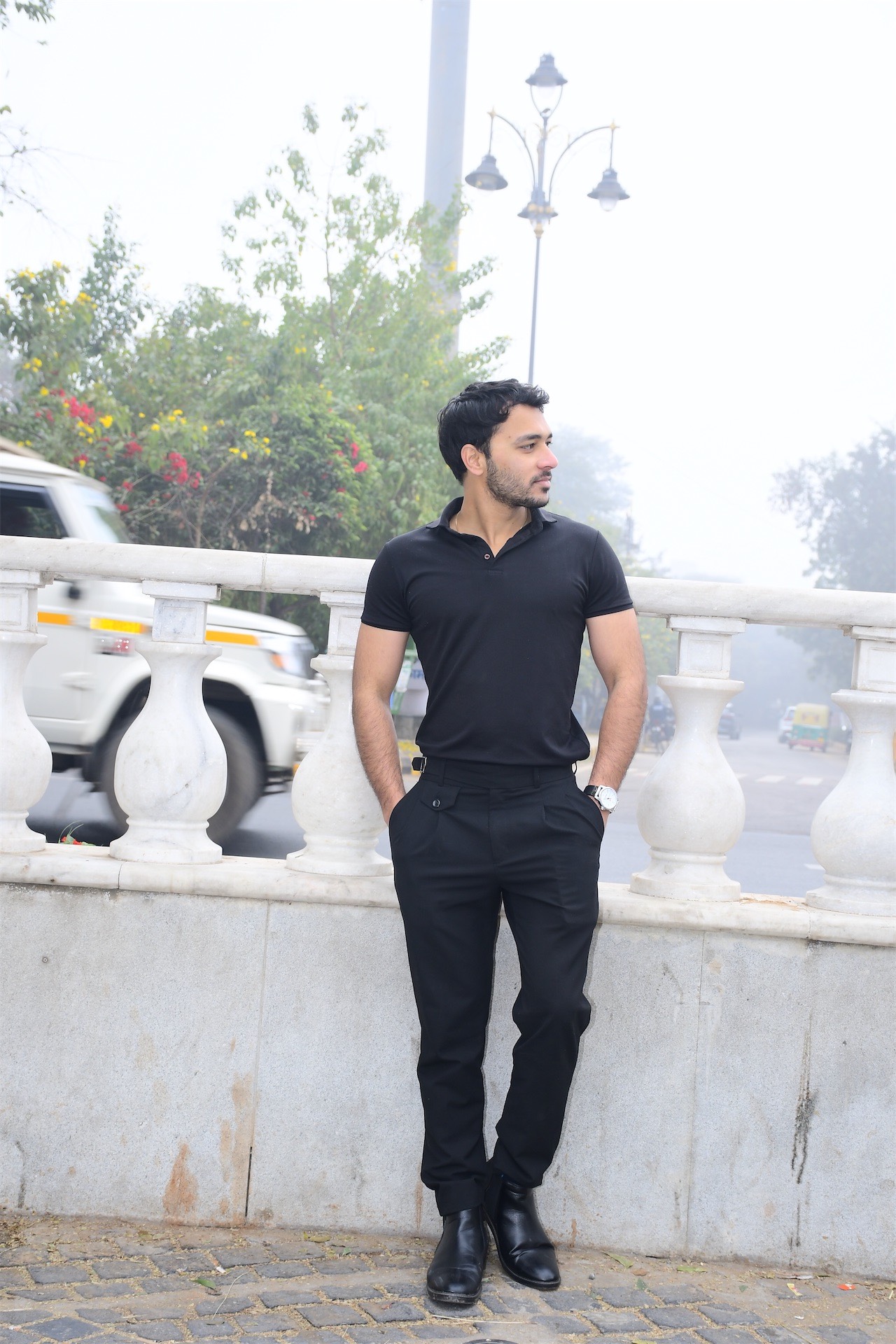 Man in black outfit on street