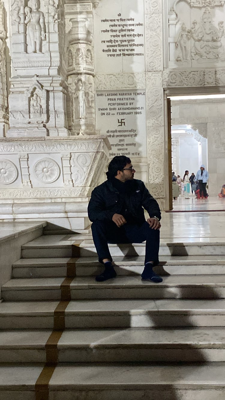 Man sitting at temple steps